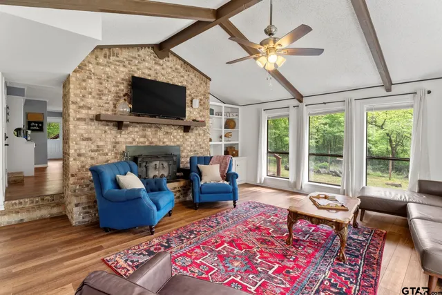 a living room with furniture fireplace and flat screen tv