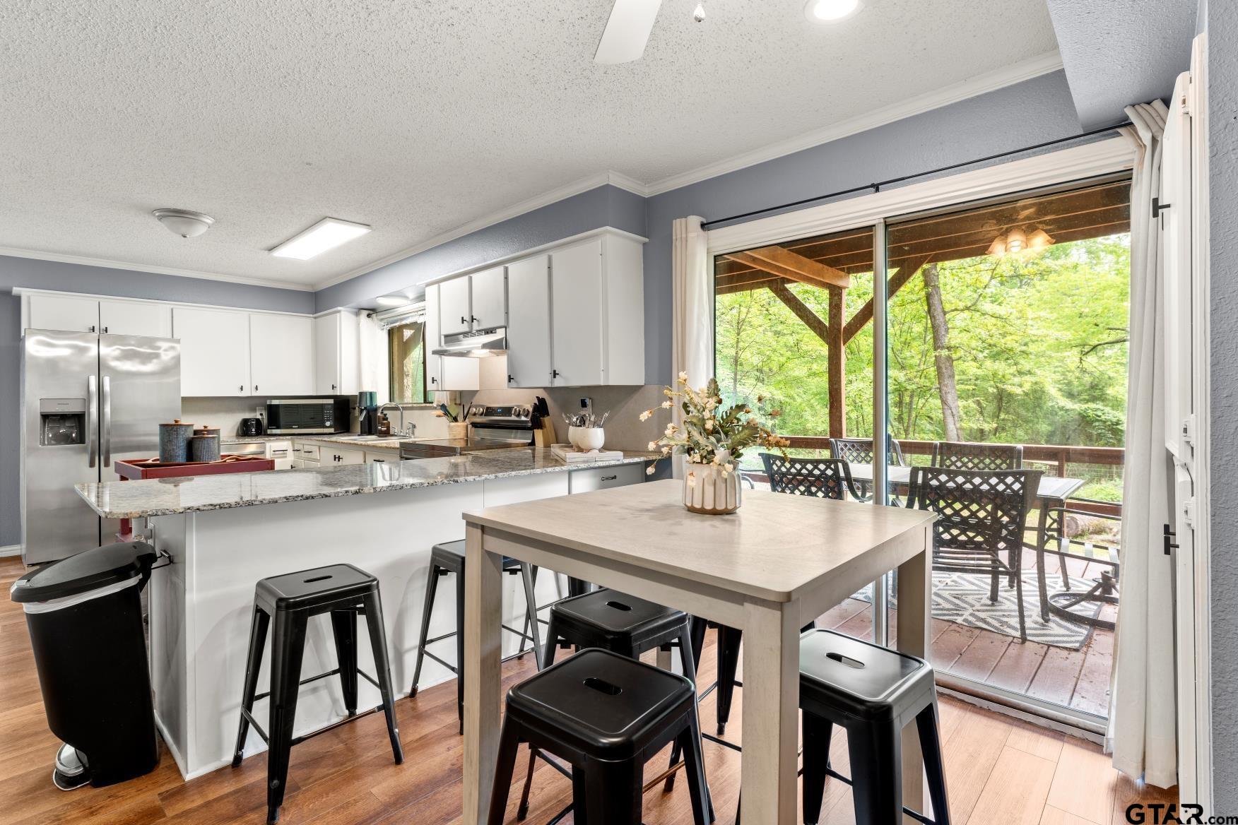 1614 County Road 2600 Mount Pleasant, TX 75455 - Photo 23 of 27 a kitchen with a table chairs sink and cabinets