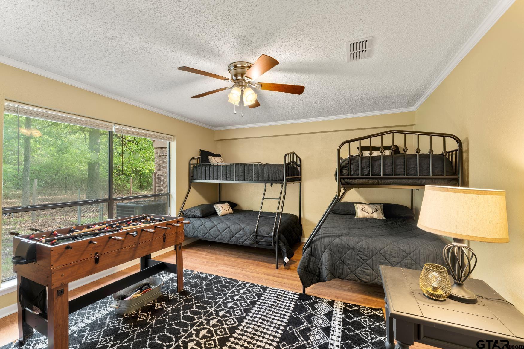 1614 County Road 2600 Mount Pleasant, TX 75455 - Photo 3 of 27 a bedroom with furniture and a window