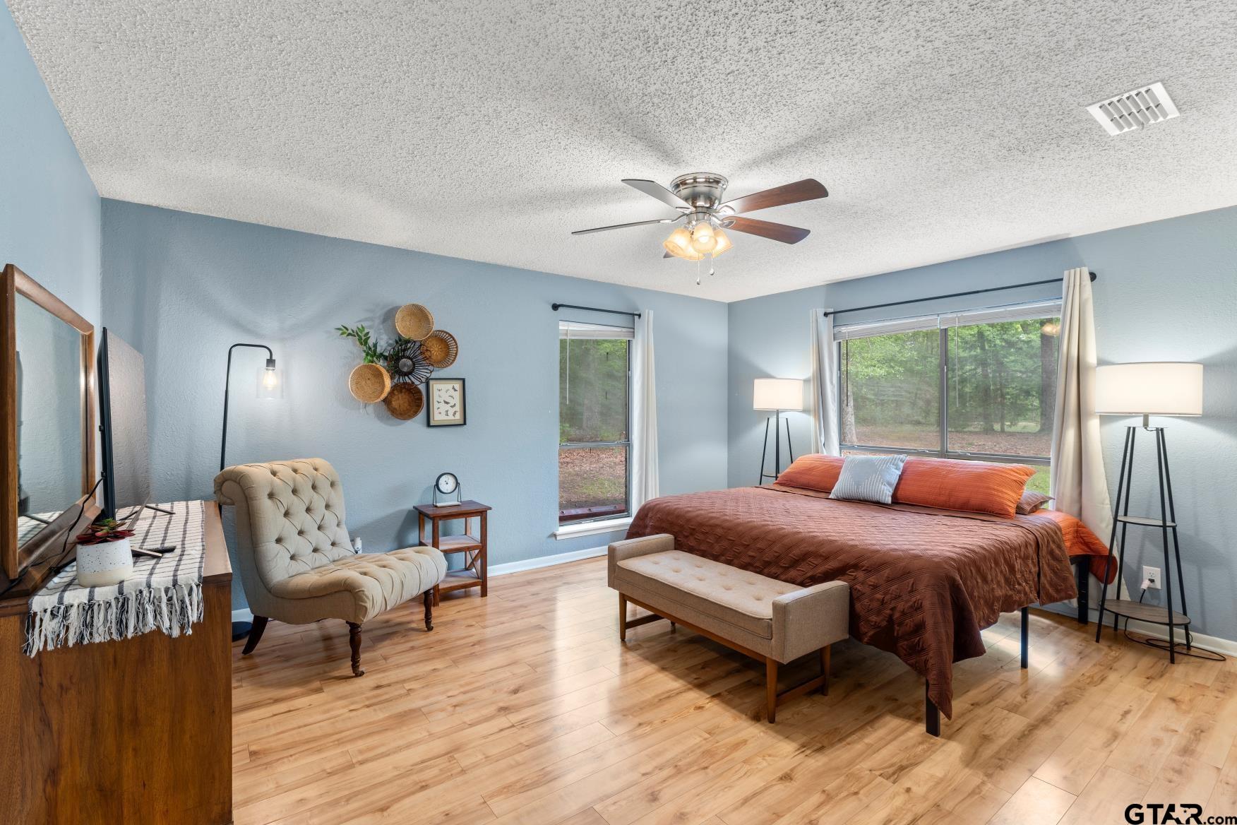 1614 County Road 2600 Mount Pleasant, TX 75455 - Photo 7 of 27 a bedroom with a bed wooden floor and a table