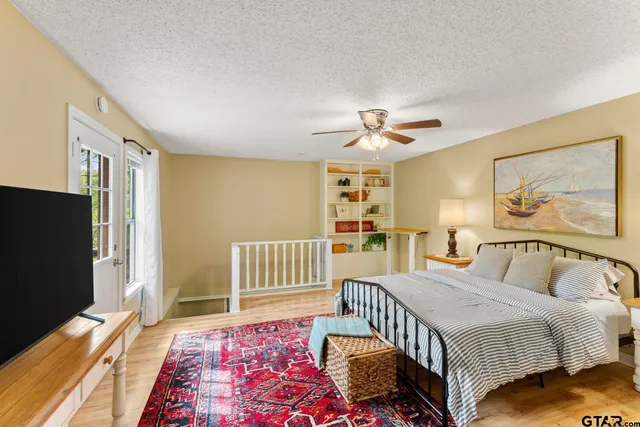 a bedroom with a bed and a flat screen tv