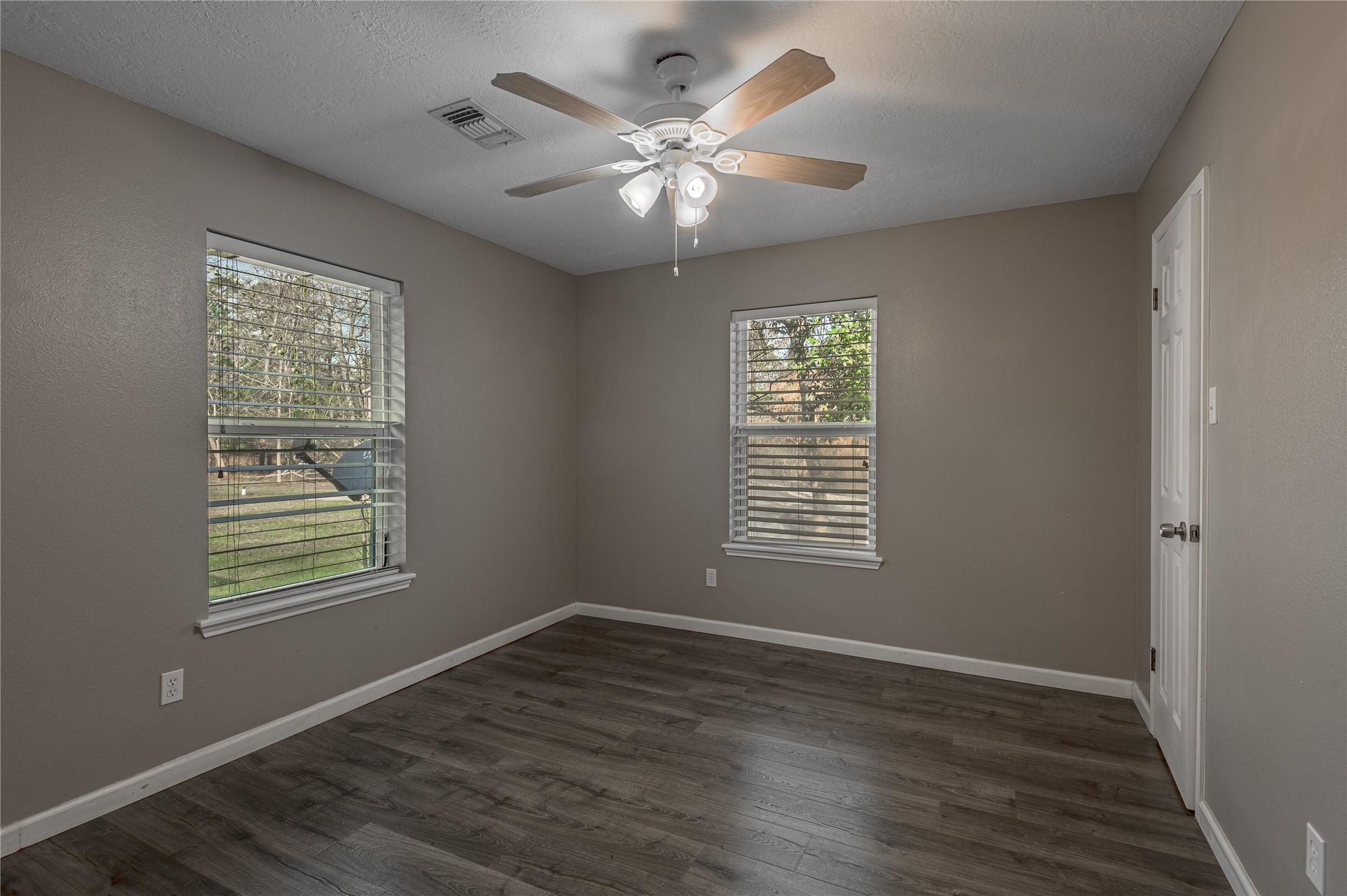 1022 Landing Way Trinity, TX 75862 - Photo 17 of 30 a view of an empty room with wooden floor and a window