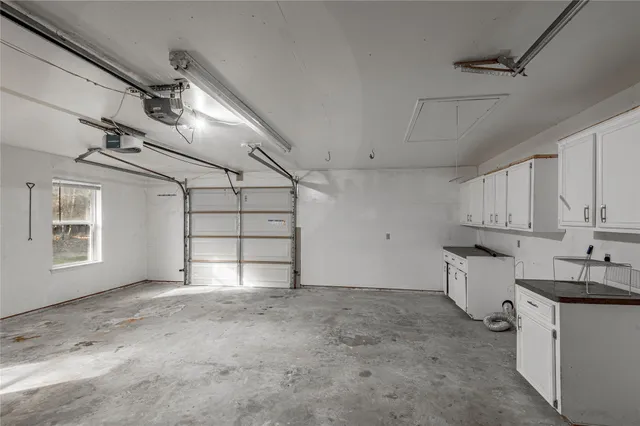 a view of a kitchen with refrigerator and window