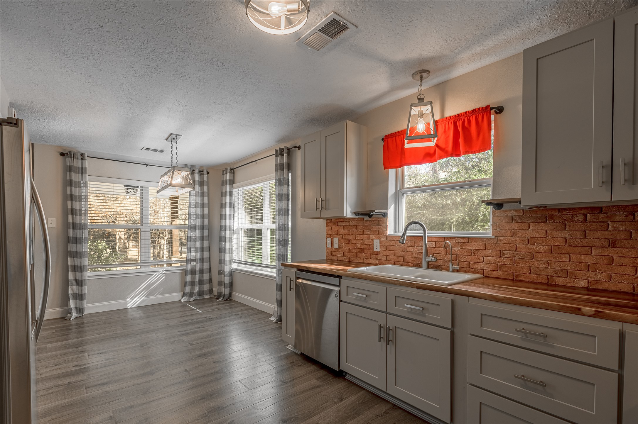 1022 Landing Way Trinity, TX 75862 - Photo 8 of 30 a kitchen with stainless steel appliances granite countertop a stove a sink and a refrigerator