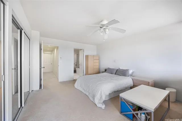 a bedroom with bed and a chandelier