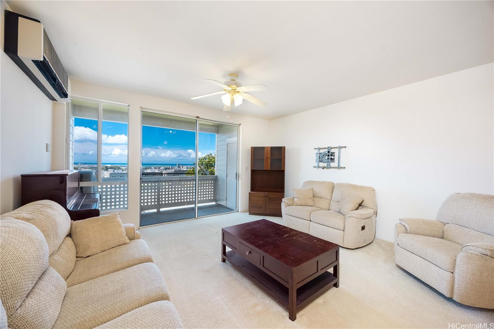 1305E Moanalualani Place, Unit 25C Honolulu, HI 96819 - Photo 2 of 21 a living room with furniture ceiling fan and a rug