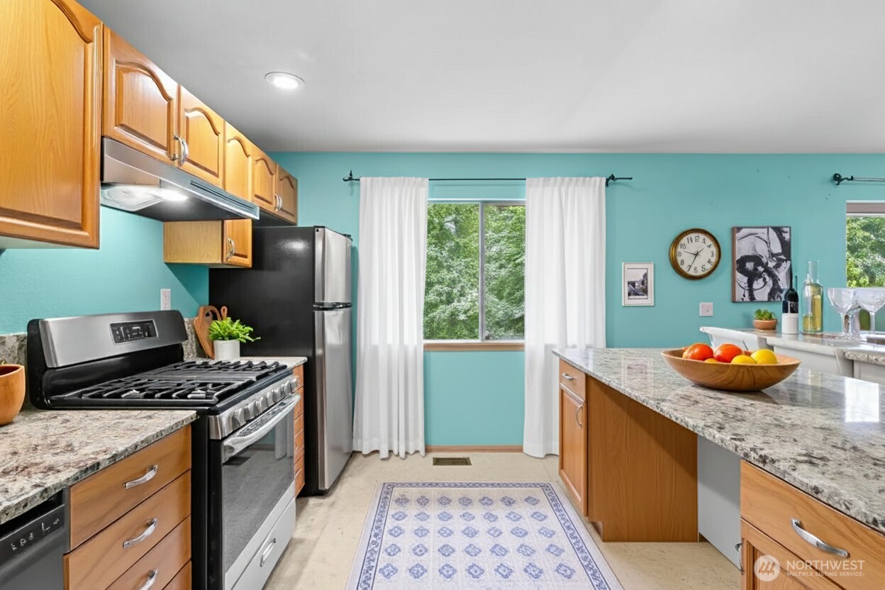 605 40th Place Everett, WA 98201 - Photo 24 of 39 a kitchen with stainless steel appliances granite countertop a refrigerator a stove and a sink