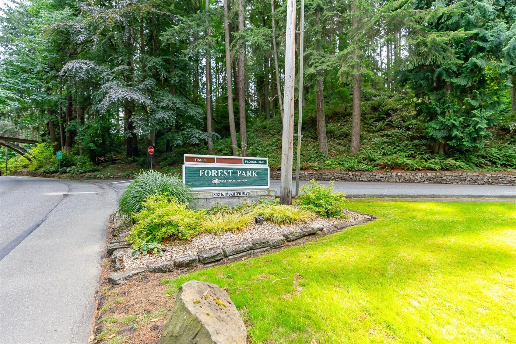 605 40th Place Everett, WA 98201 - Photo 39 of 39 a view of a swimming pool with a bench and trees in the background