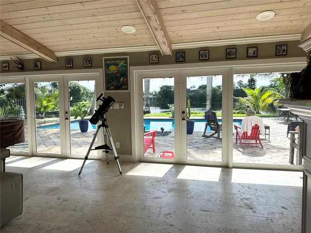 a living room with a fireplace a flat screen tv and a window