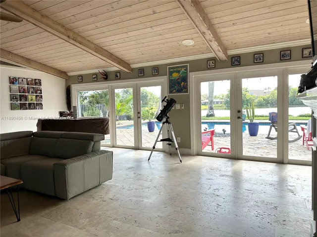 a living room with furniture and flowers