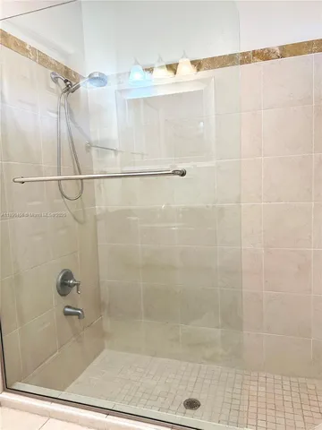 a bathroom that has a glass shower door