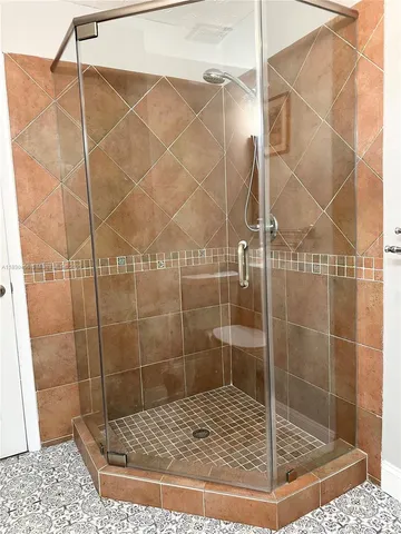 a bathroom with a toilet and a shower
