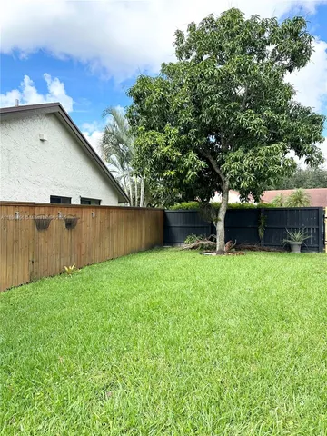 a backyard of a house with lots of green space