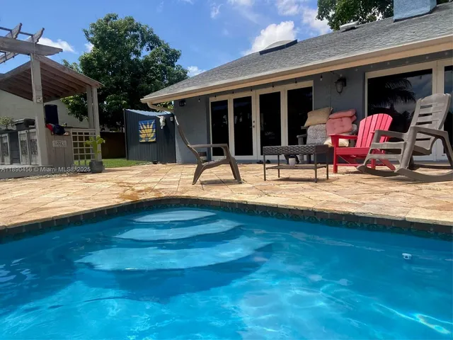 a house with swimming pool in front of it