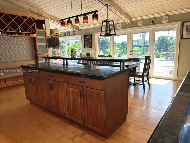 a kitchen with stainless steel appliances granite countertop a stove a sink and a wooden cabinets