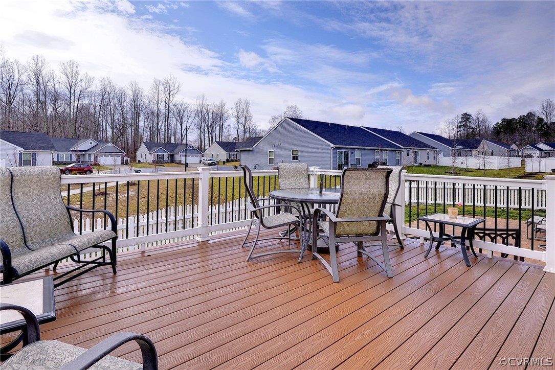 204 Arbordale Loop Williamsburg, VA 23188 - Photo 24 of 41 a view of a patio with table and chairs with wooden floor and fence