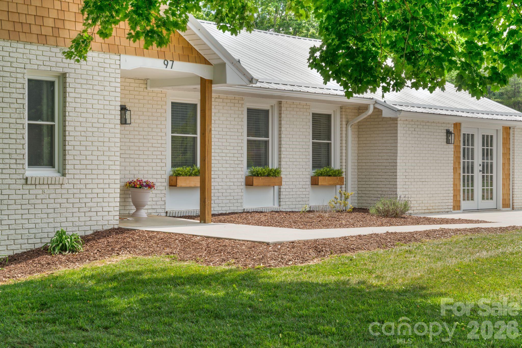 97 Paul Holland Road Canton, NC 28716 - Photo 2 of 35 a front view of a house with a garden and yard