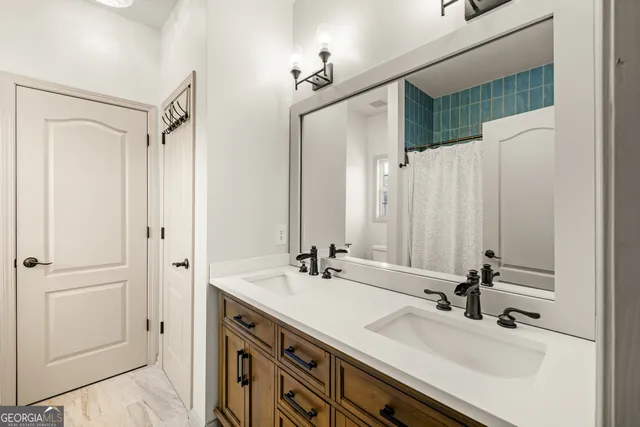 a view of a hallway with wooden floor and entryway