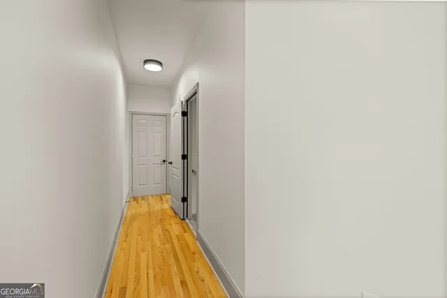 a en suite bathroom with a granite countertop sink and a large mirror