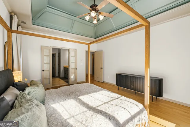a bedroom with a bed and a chandelier