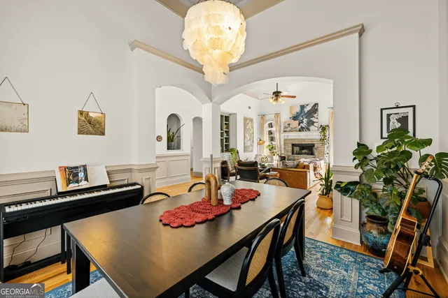 a living room with patio furniture and a chandelier