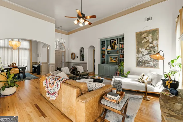 a living room with furniture fireplace and a large window