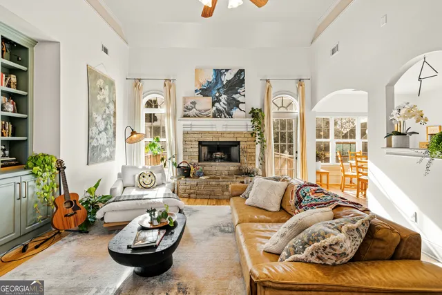 a view of living room filled with furniture and wooden floor