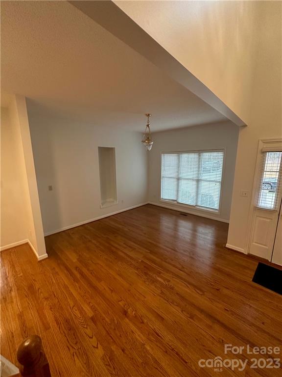 4194 Barrier Store Road Mount Pleasant, NC 28124 - Photo 2 of 12 an empty room with wooden floor and windows