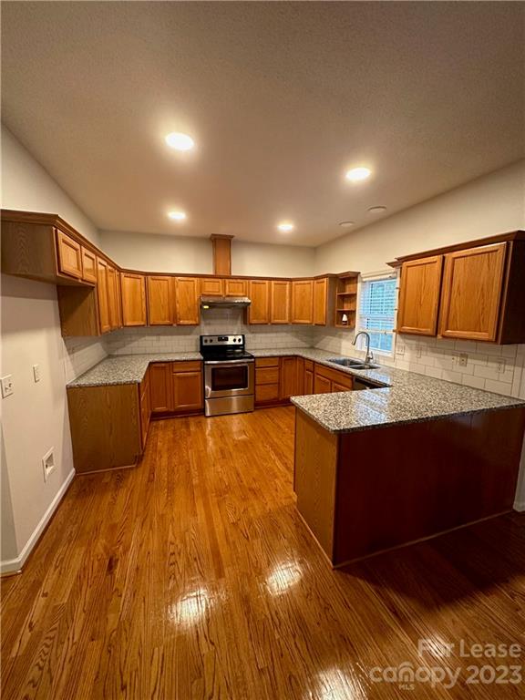 4194 Barrier Store Road Mount Pleasant, NC 28124 - Photo 4 of 12 a large kitchen with stainless steel appliances a large counter top a stove and a sink