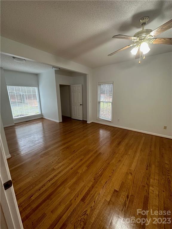 4194 Barrier Store Road Mount Pleasant, NC 28124 - Photo 6 of 12 an empty room with wooden floor and windows