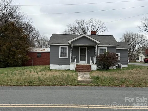 a front view of a house with a yard garage and outdoor seating