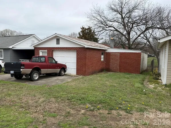 a front view of a house with a garden and garage