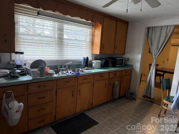 a kitchen with sink a window and cabinets
