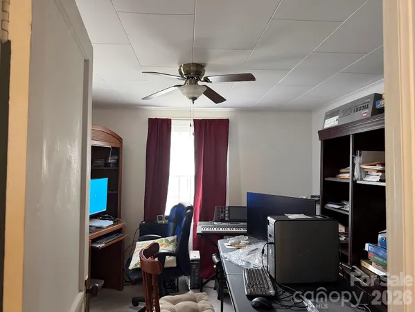 a workspace with furniture window and a ceiling fan