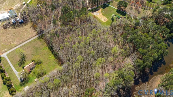 a aerial view of a house with a yard and wooden fence