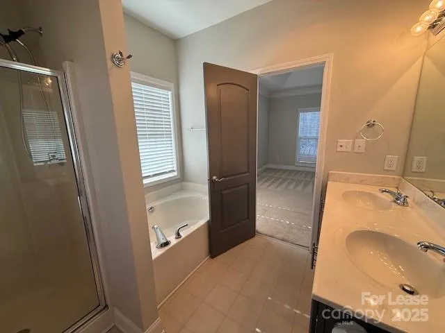 a bathroom with a tub sink and a mirror