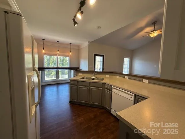 a large kitchen with stainless steel appliances granite countertop a large window and a counter space