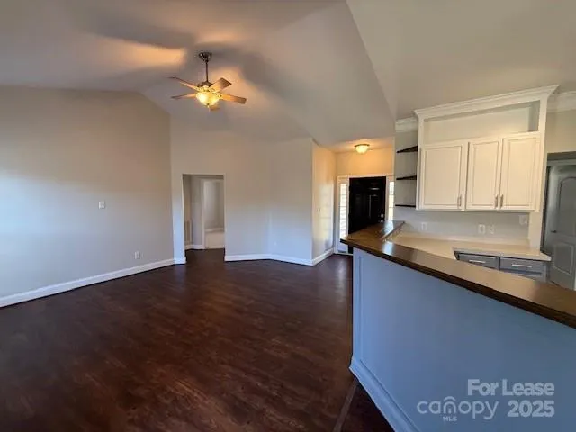 a view of kitchen with granite countertop living room