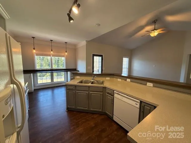 a large white kitchen with a large window