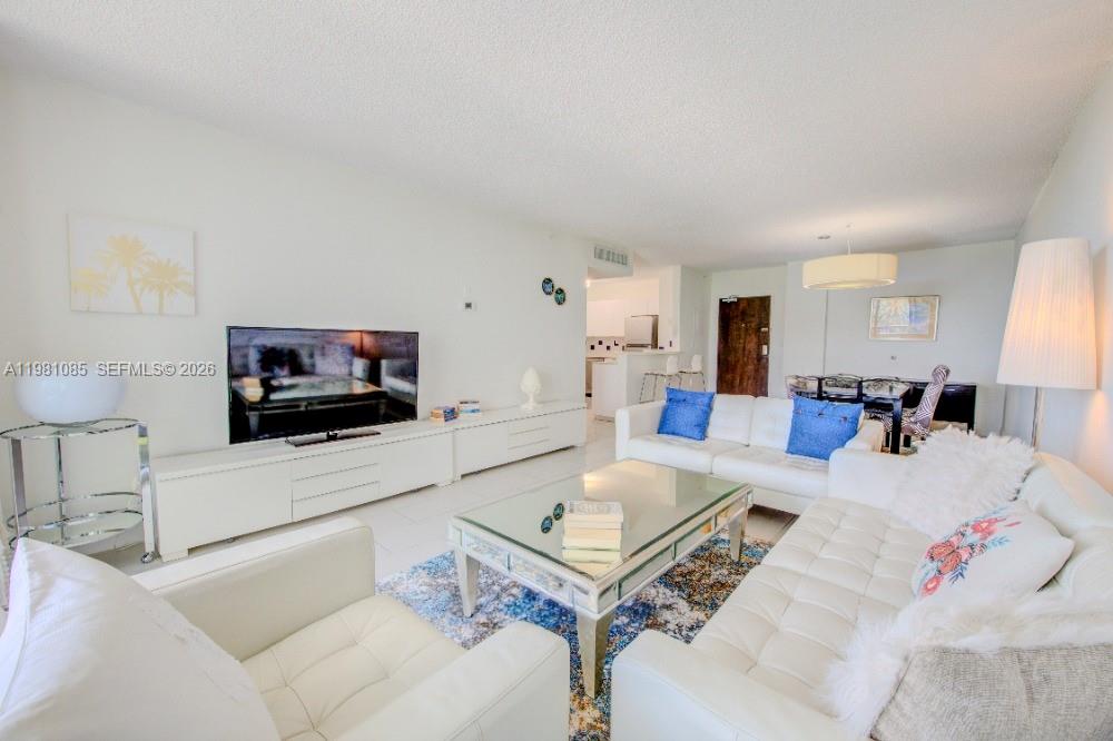 1500 Bay Road, Unit 528S Miami Beach, FL 33139 - Photo 5 of 11 a living room with furniture and a flat screen tv