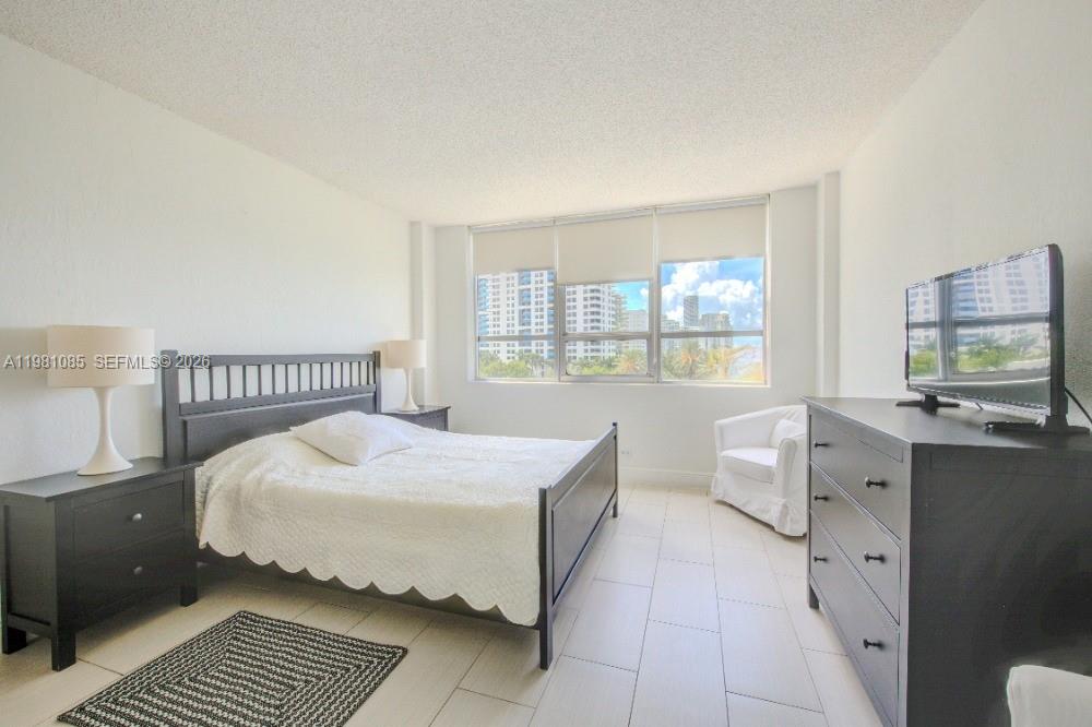 1500 Bay Road, Unit 528S Miami Beach, FL 33139 - Photo 9 of 11 a bedroom with a bed and window