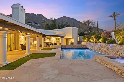 a view of swimming pool with a chairs