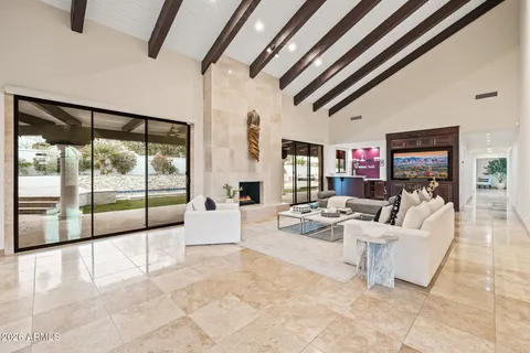 a living room with furniture and a floor to ceiling window