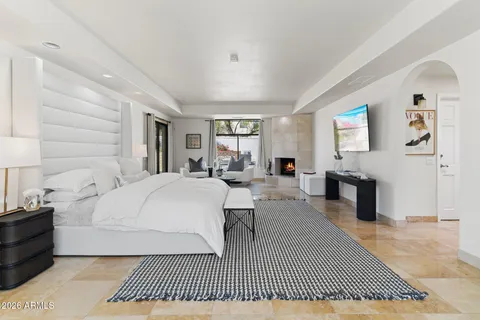 a bedroom with a large bed and a couch