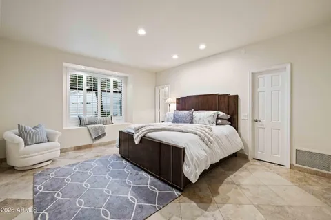 a bedroom with a bed and glass window