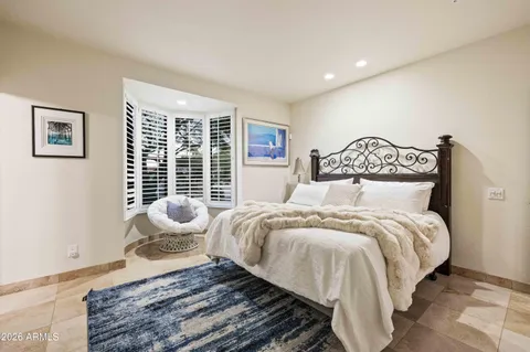 a bedroom with bed and wooden floor