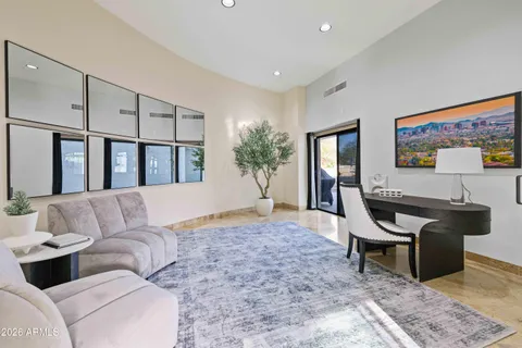 a living room with furniture and a piano