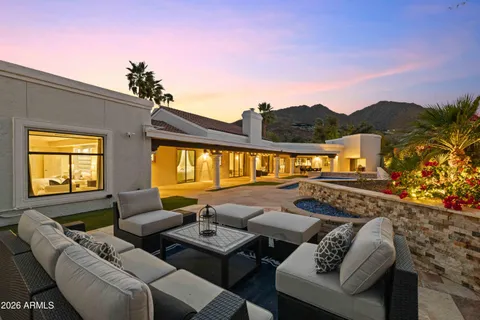 a roof deck with couches and potted plants