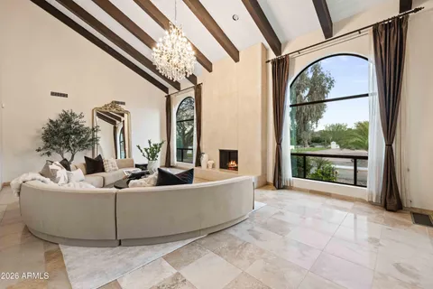 a living room with furniture and a floor to ceiling window