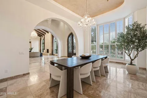 a view of a dining room with furniture and a chandelier